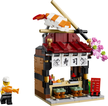 LEGO 40906 Restaurants du monde Japon - Vue de face du restaurant à sushi avec minifigurine de chef tenant un poisson