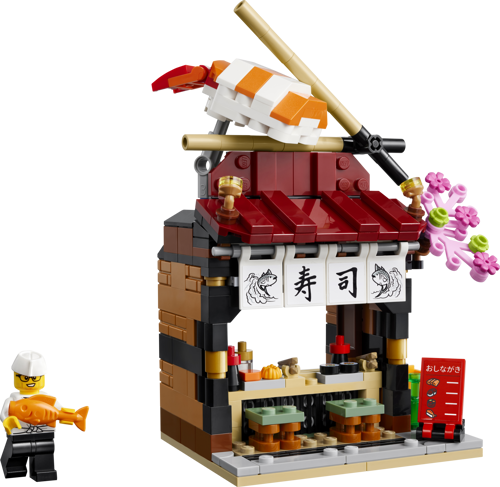 LEGO 40906 Restaurants du monde Japon - Vue de face du restaurant à sushi avec minifigurine de chef tenant un poisson