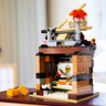 Vue arrière du LEGO 40906 montrant l'intérieur du restaurant avec le chef préparant des sushis derrière le comptoir