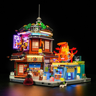 Vue de face du set Izakaya F9073 éclairé de nuit avec lumières LED multicolores, izakaya japonais et boutique à pieuvre