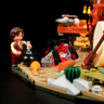 Minifigurine féminine cuisinant près du feu de camp avec chaudron, carotte, cactus et chariot western éclairé