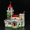 Vue de face du château Lumibricks L9119 éclairé sur fond noir avec tour, remparts, figurines de chevaliers et végétation fleurie